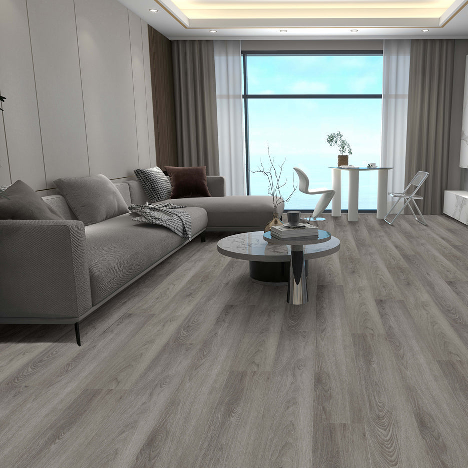 Modern living room with gray flooring, furniture, and decor.